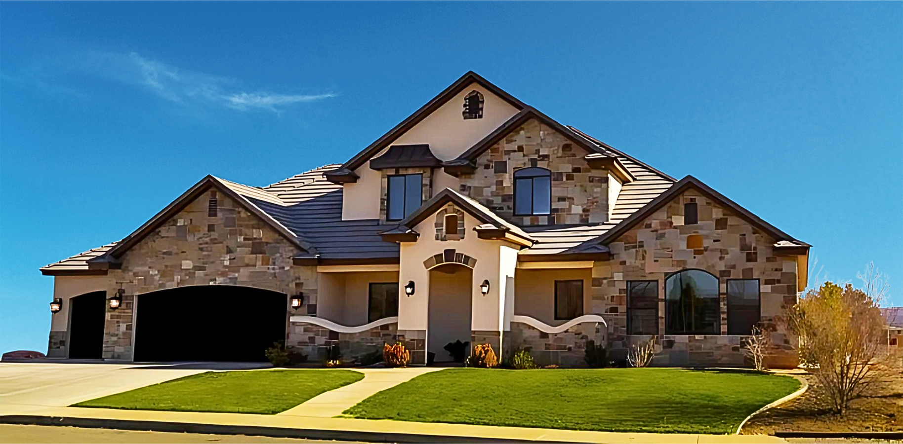 Beige and brown house with stone exterior and green lawn